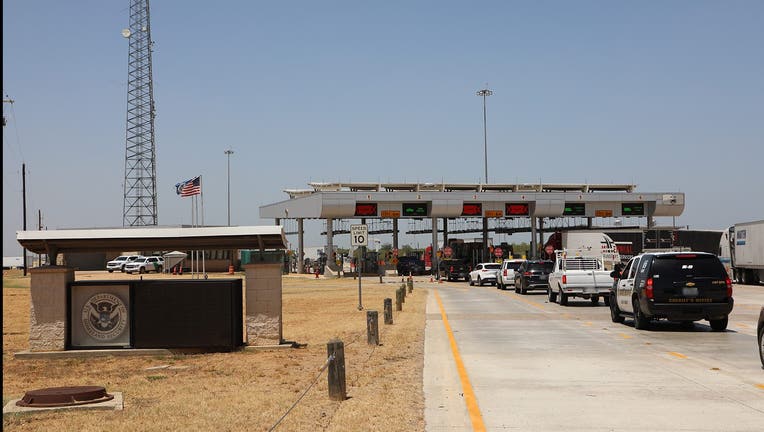 Border patrol checkpoint with cars in a line