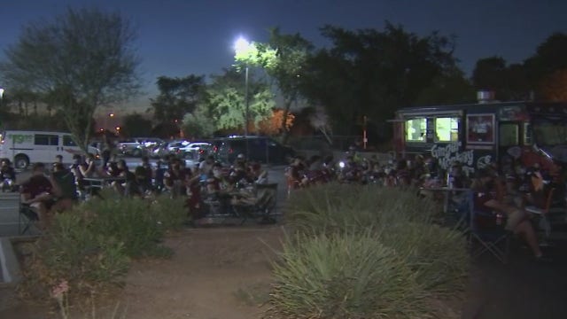 High school football players gather after game was cancelled due to COVID-19