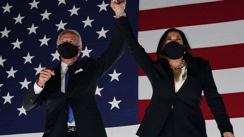 Former vice-president and Democratic presidential nominee Joe Biden (L) and Senator from California and Democratic vice presidential nominee Kamala Harris greet supporters outside the Chase Center in Wilmington, Delaware, at the conclusion of the Democratic National Convention, held virtually amid the novel coronavirus pandemic, on August 20, 2020.