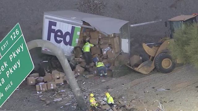 FedEx truck goes off I-10, crashes into barrier and sign
