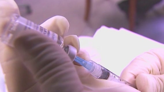 Chandler doctor providing COVID-19 vaccine to his patients in office