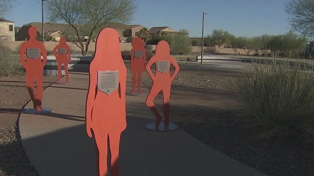 Wooden silhouettes honor victims of domestic violence at Peoria park