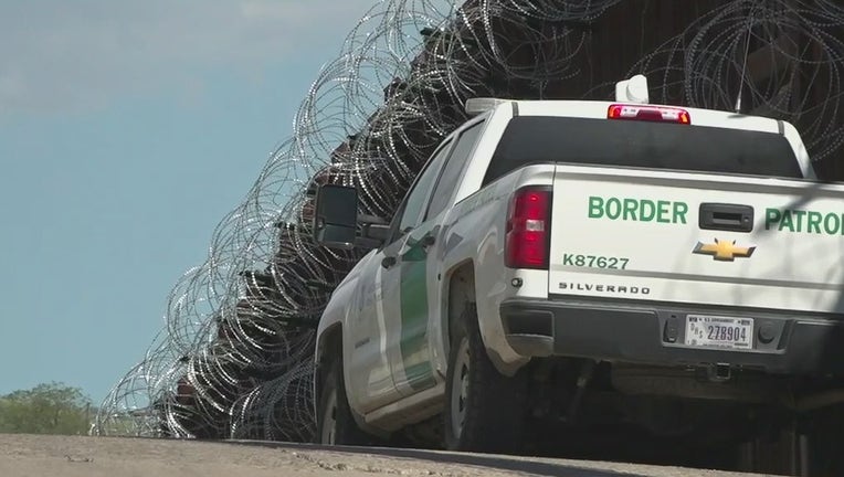 A Border Patrol truck next to the U.S. - Meixco border wall.