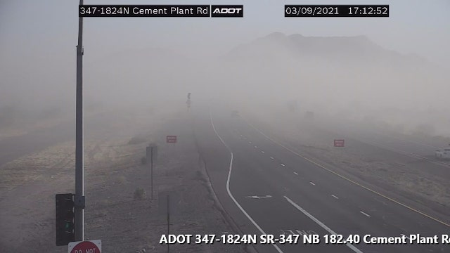 Blowing dust reducing visibility along highway south of Phoenix