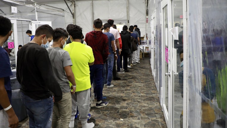 Unaccompanied minors wait in line to receive food and drink from a worker at the temporary processing facility in Donna, Texas. (Photo: U.S. Customs and Border Protection / Jaime Rodriguez Sr)