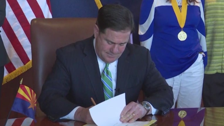 Arizona Gov. Doug Ducey signs a bill