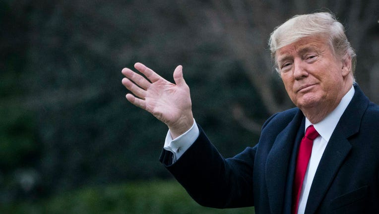 66d15253-U.S. President Donald Trump and First Lady Melania Trump walk along the South Lawn to Marine One as they depart from the White House for a weekend trip to Mar-a-Lago on January 31, 2020 in Washington, DC. Senators are expected to debate and then vote on whether to include additional witnesses and documents today in the Senate impeachment trial of President Trump.