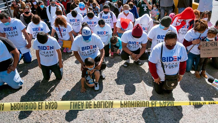 Migrants wear Biden T-shirts at US-Mexico border, demand clearer