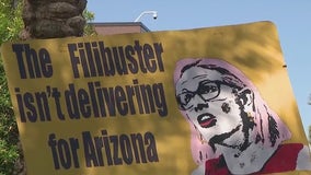 Protesters gather outside of Sen. Sinema's Phoenix office after missing Capitol riot commission vote