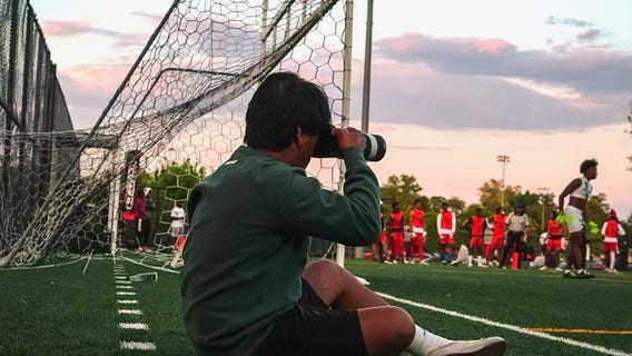 Sports photographer pursues dream despite losing arm, fingers in house fire