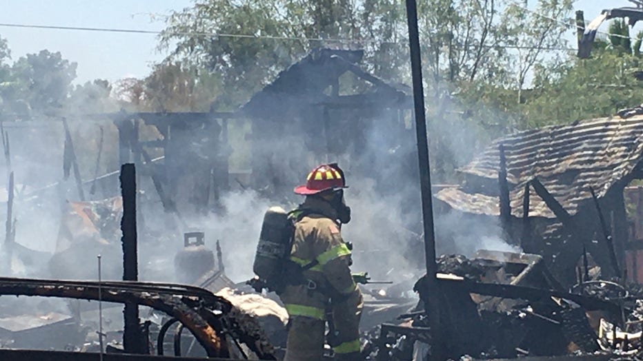 Arizona firefighter standing in front of rubble