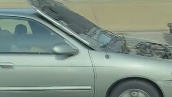 Flipped hood blocks motorist's view while driving miles on I-43