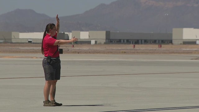 Workers at airport tarmac endure extreme temperatures as travellers try to escape the heat