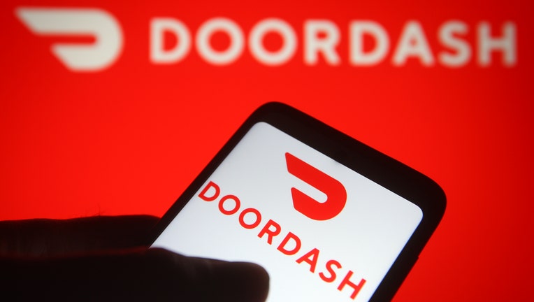 In this photo illustration the DoorDash logo of an US online