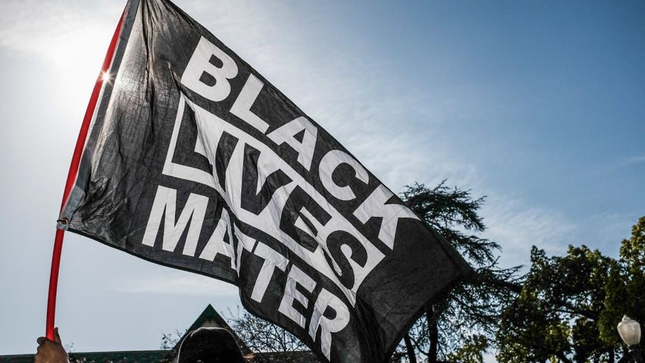 A protester waves a Black Lives Matter flag during the