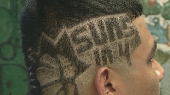 Phoenix Suns fan gets hair buzzed to show his support for the team