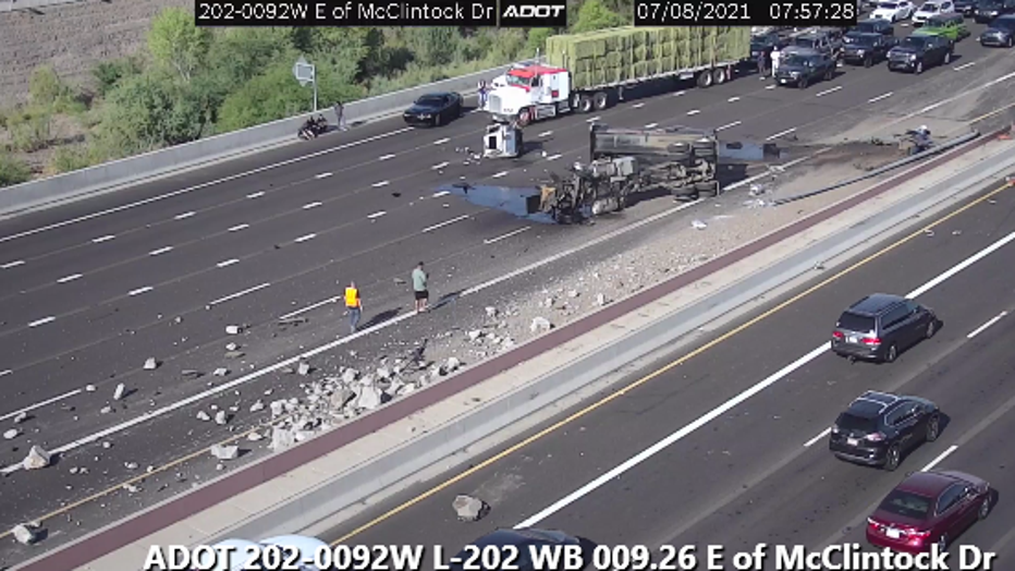 An overturned dump truck is causing major delays on Loop 202.