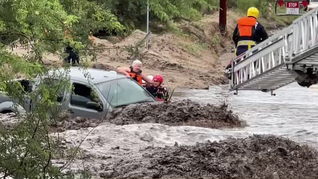 Crews rescue 3 from vehicle in runoff-swollen Tucson wash