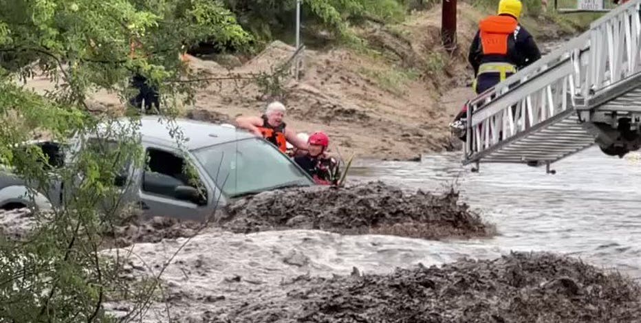 Crews rescue 3 from vehicle in runoff-swollen Tucson wash