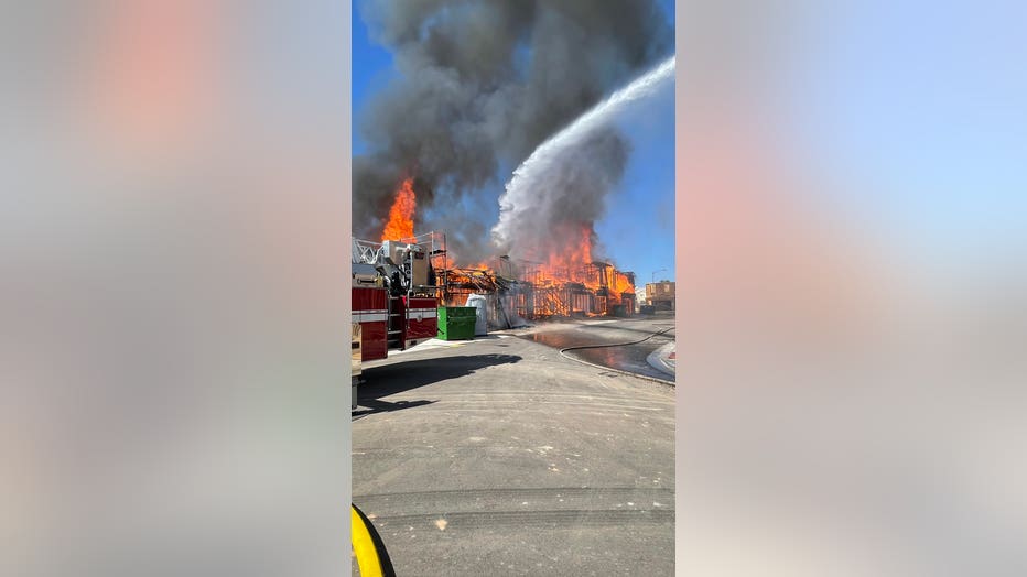 Firefighters work to get a fire at a construction site under control.