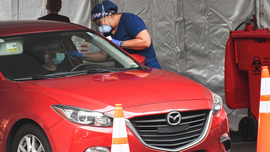 A man receives a nasal test at a drive-thru COVID-19 testing