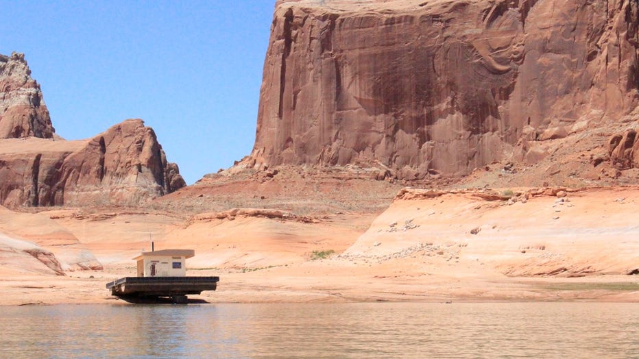 Changing lake levels has left this floating restroom stranded on rock in Lake Powell.