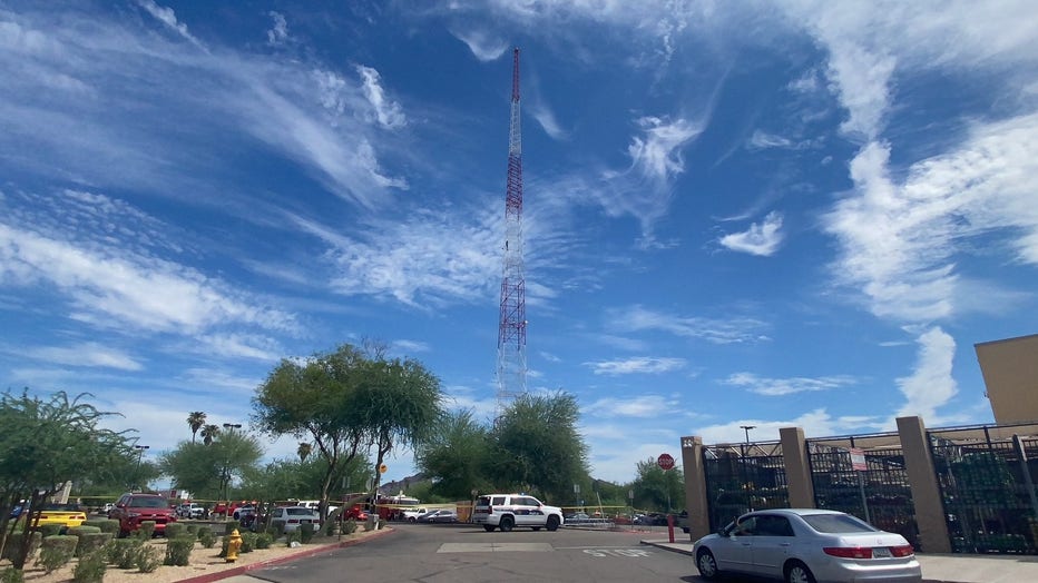 A man can be seen midway up a radio tower near a Walmart on 36th Street and Thomas.