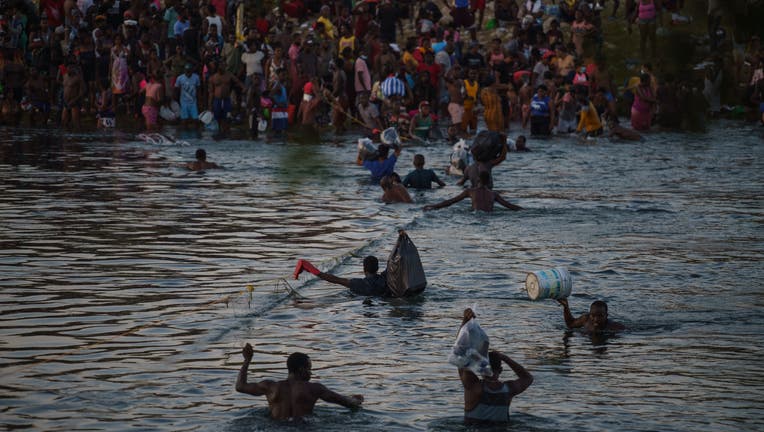 Haitian migrants continue to cross the US-Mexico border on the Rio Grande, as seen from Ciudad Acuna, Coahuila state, Mexico.