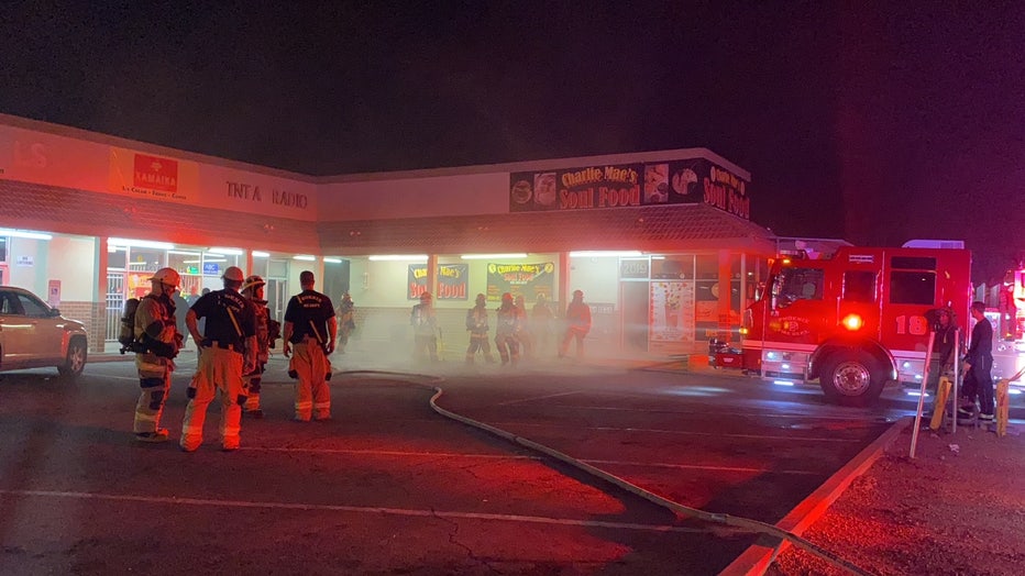 Firefighters extinguish a fire at Charlie Mae's Soul Food.