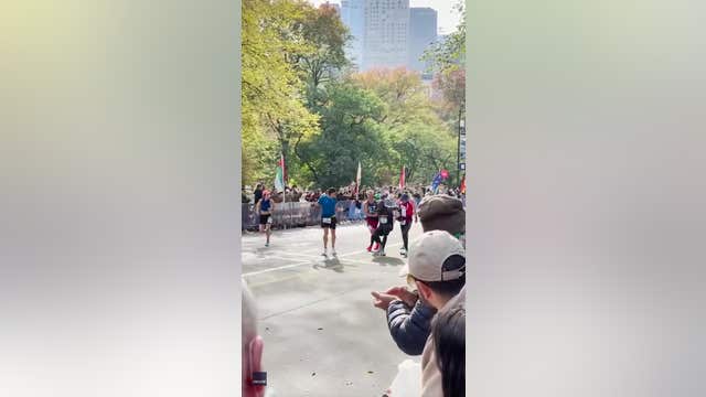 2 runners stop to help fellow runner over NYC Marathon finish line