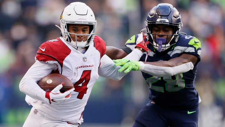 Rondale Moore #4 of the Arizona Cardinals catches the ball and runs passed Ugo Amadi #28 of the Seattle Seahawks during the fourth quarter at Lumen Field on November 21, 2021 in Seattle, Washington. 