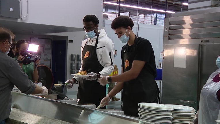 Cam Johnson serves food to those in need ahead of Thanksgiving