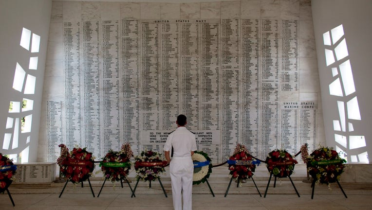 Vice Admiral Michael Vitale pauses for a moment in the shrine room of the USS Arizona Memorial during a memorial service for the 69th anniversary of the attack on the U.S. naval base at Pearl Harbor on the island of Oahu on December 7, 2010 in Pearl Harbor, Hawaii.
