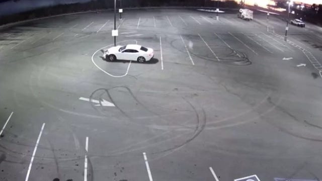 Driver doing donuts hits light pole, gets arrested