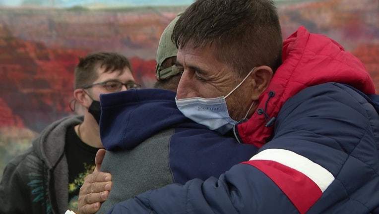 Mhammad Armin Khalili hugging a person who helped get him out of Afghanistan at Sky Harbor.