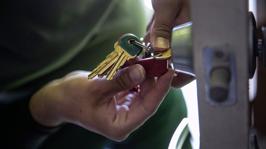 An apartment maintenance man changes the lock of an apartment after constables posted an eviction order
