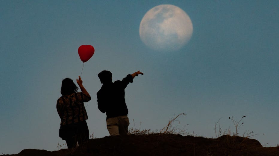 FILE - A couple is seen on top of a hill with a heart shaped balloon in Navi Mumbai, India, on Feb. 13, 2022. (Photo by Pratik Chorge/Hindustan Times via Getty Images)