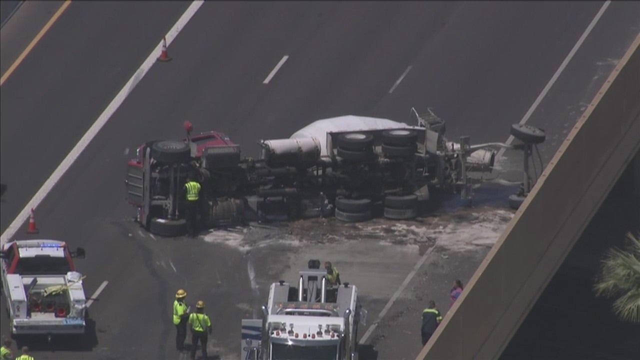 Cement truck rolls over on SR 51 in Phoenix, spilling fuel and concrete