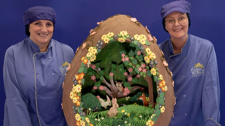 Cadbury World chocolatiers Donna Oluban and Dawn Jenks are pictured with the chocolate egg creation. Credit: Provided / Cadbury World