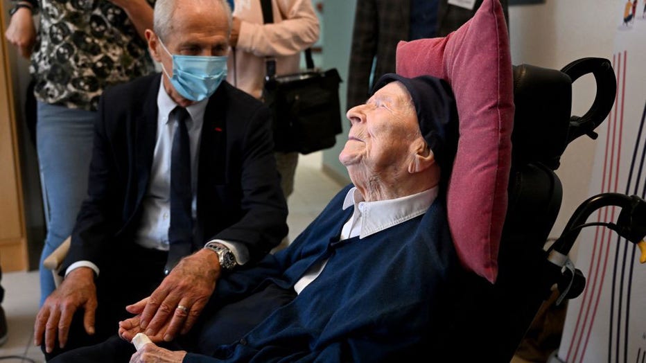 Toulon's mayor Hubert Falco (L) speaks with 118-year-old French catholic nun Lucile Randon at the Saint-Catherine-Laboure nursing home where she lives in Toulon, southern France, on April 26, 2022, after she became the world's oldest known person following the death announced the day before of a Japanese woman one year her senior. (Photo by CHRISTOPHE SIMON/AFP via Getty Images)