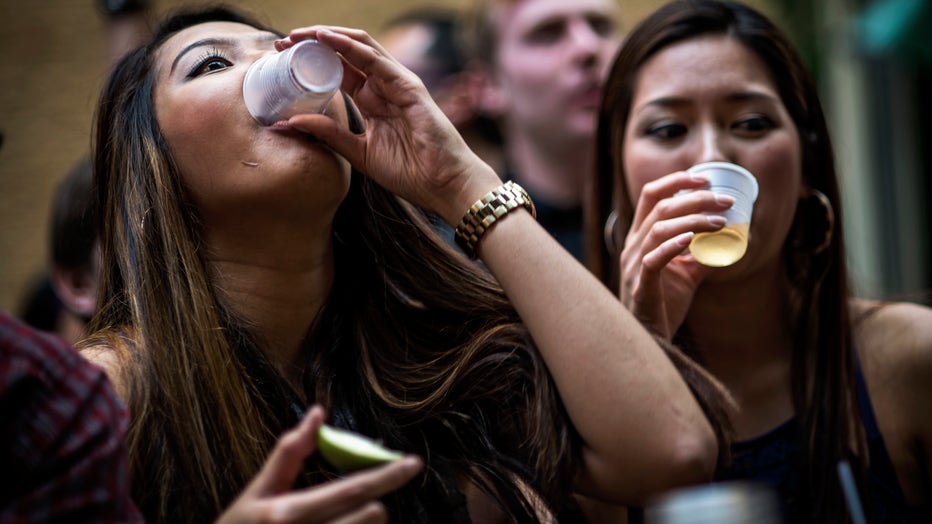 Two women down shots of liquor during a Cinco de Mayo bar crawl event in Arlington, Virginia. (Photo by J. Lawler Duggan/For The Washington Post via Getty Images)