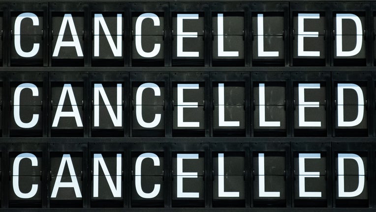 A board displays cancelled flights (Photo by SILAS STEIN/dpa/AFP via Getty Images)
