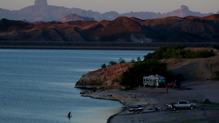  Campers find a secluded spot framed by the desert landscape on the shore of Lake Martinez, a recreation and residential area above the Imperial Dam in Yuma. The dam desilts Colorado River water and diverts it to farmlands in Arizona and California. Some of the water is released into the Gila River, a stream that starts in New Mexico and runs through Arizona, that once was a major tributary of the Colorado River. 