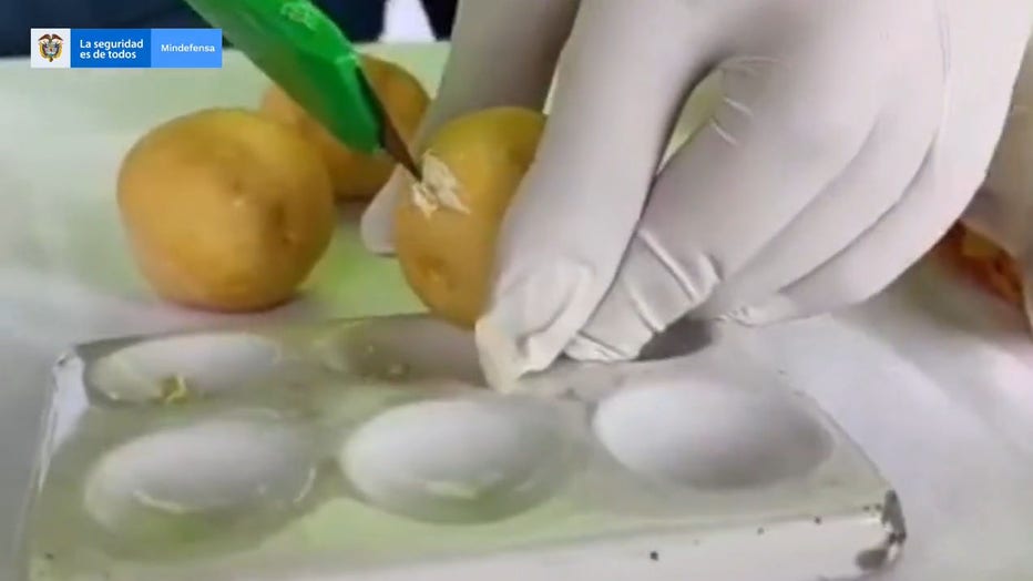 A screengrab from a video shared by Colombia’s Ministry of National Defense shows the cocaine shipment disguised as potatoes and other foods. (Credit: Colombia’s Ministry of National Defense / Twitter)