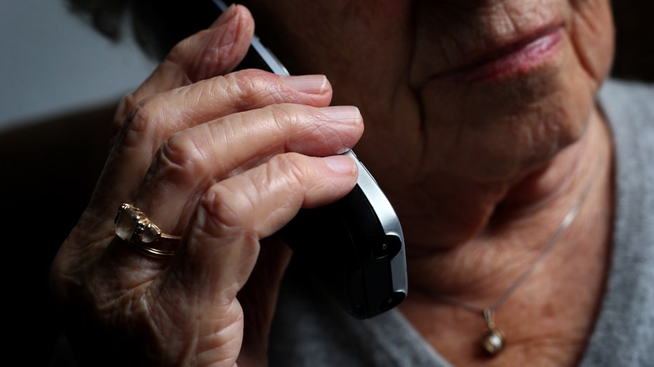 An elderly woman is using a landline phone (Photo by Karl-Josef Hildenbrand/picture alliance via Getty Images)