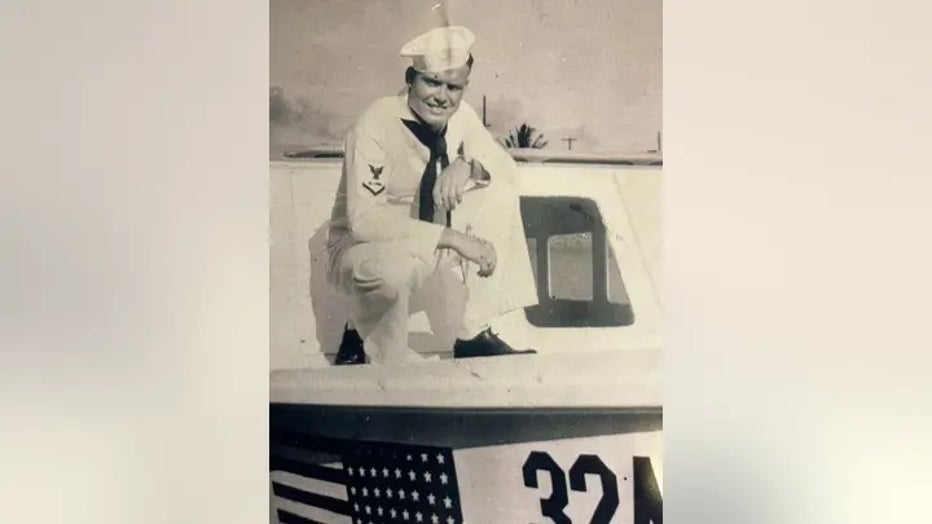 Hubert-Malicote-in-Navy-Uniform-on-Vehicle.jpg