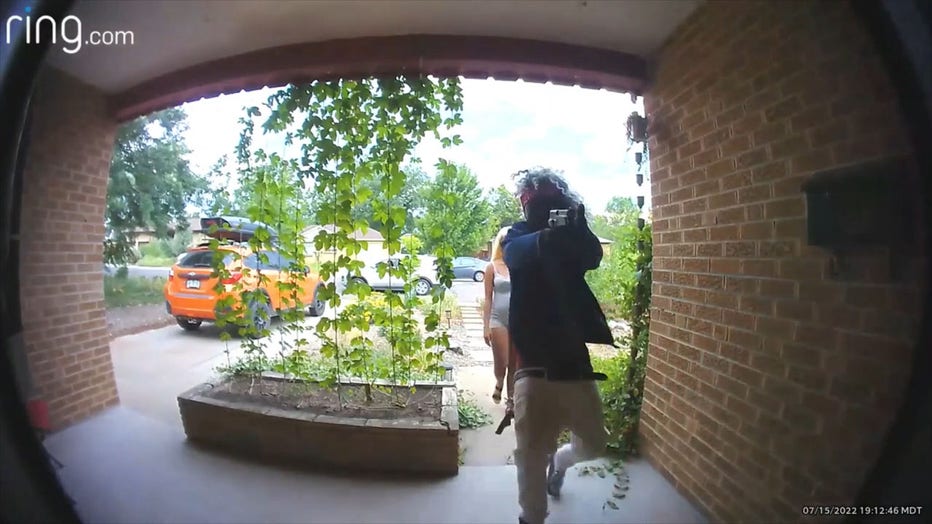 The suspect is pictured pointing a gun at the couple, along with a second individual, on July 15, 2022, in Wheat Ridge, Colorado. (Credit: Wheat Ridge Police Department via Storyful)