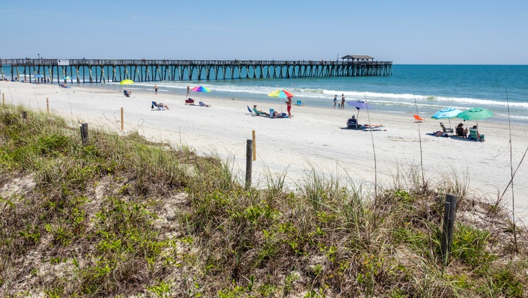 b4fa92a3-South Carolina, Myrtle Beach, Atlantic Ocean, Myrtle Beach State Park, sunbathers and fishing pier