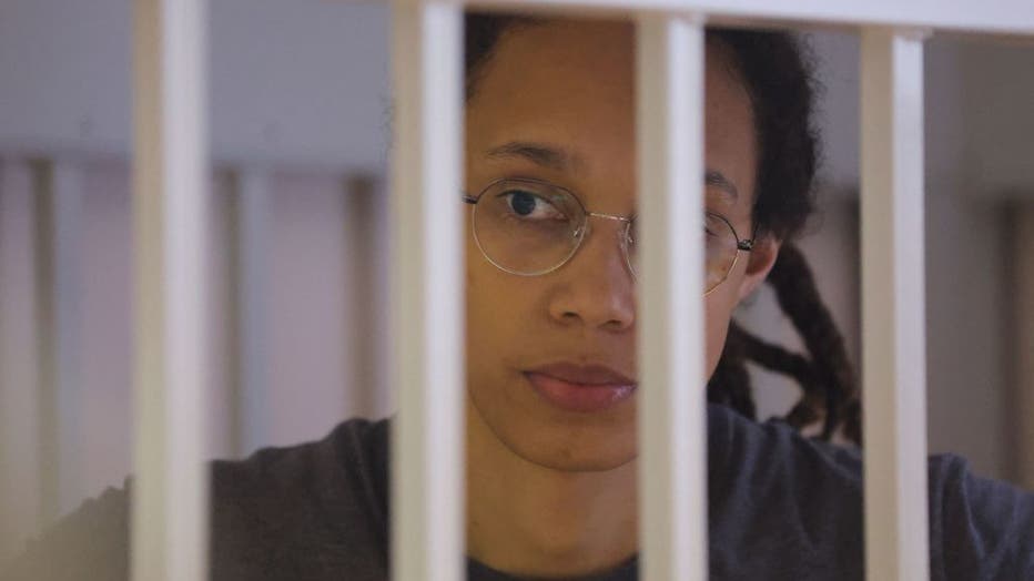 US Women's National Basketball Association (NBA) basketball player Brittney Griner, who was detained at Moscow's Sheremetyevo airport and later charged with illegal possession of cannabis, waits for the verdict inside a defendants' cage before a court hearing in Khimki outside Moscow, on August 4 , 2022. (Photo by EVGENIA NOVOZHENINA/POOL/AFP via Getty Images)