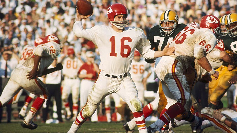FILE - Kansas City Chiefs Hall of Fame quarterback Len Dawson (16) fires a pass during Green Bay Packers Hall of Fame fullback Jim Taylor (31) takes the handoff from Hall of Fame quarterback Bart Starr (15) and follows guard Fuzzy Thurston (63) during Super Bowl I, a 35-10 loss to the Green Bay Packers on January 15, 1967, at the Los Angeles Memorial Coliseum in Los Angeles, California. (Photo by James Flores/Getty Images)